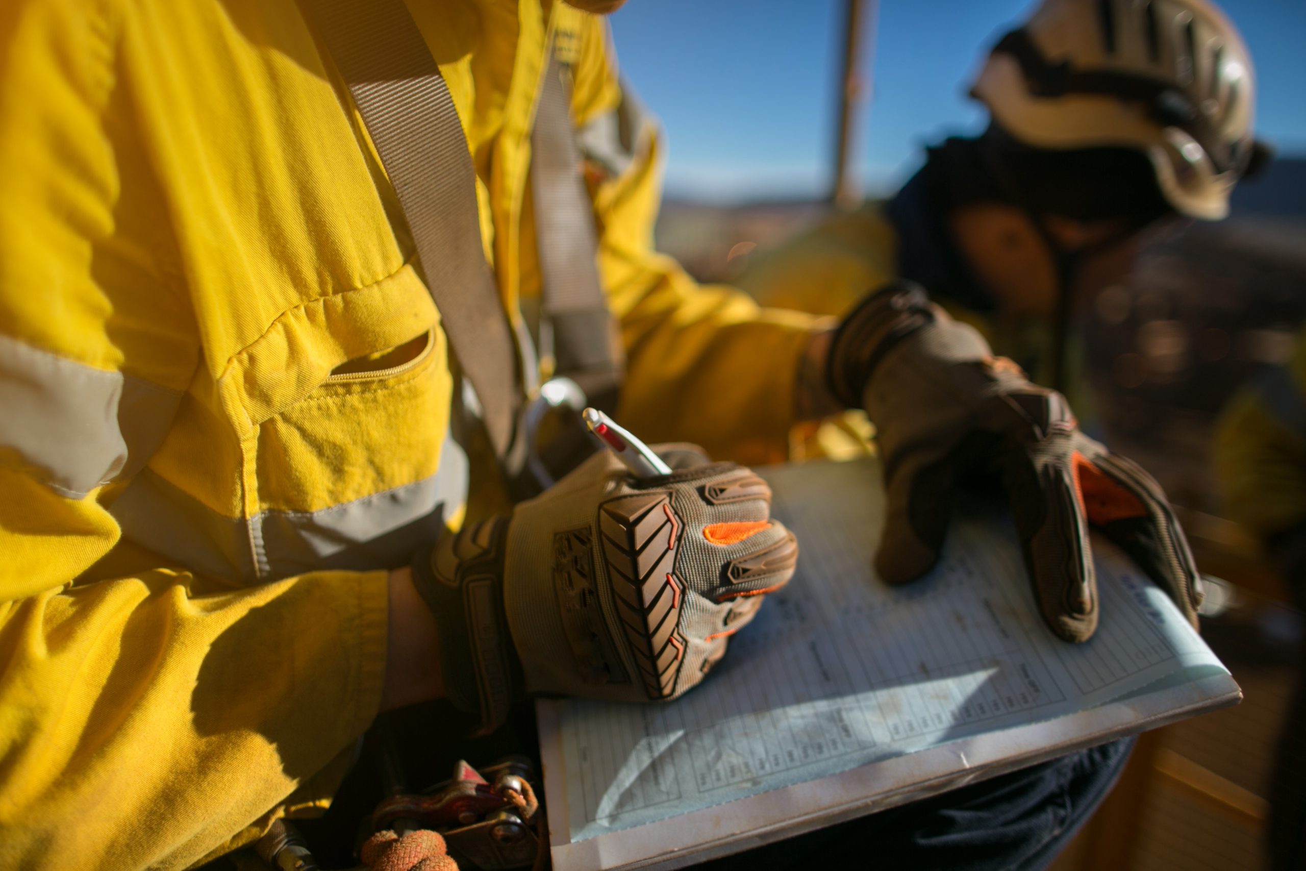 Construction workers wearing a industry safety glove signing of